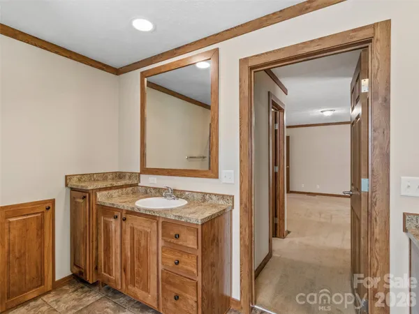 a bathroom with a granite countertop sink and a mirror