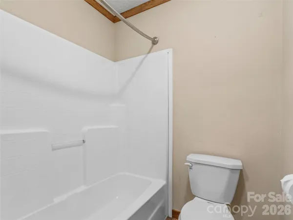 a bathroom with a toilet and tub