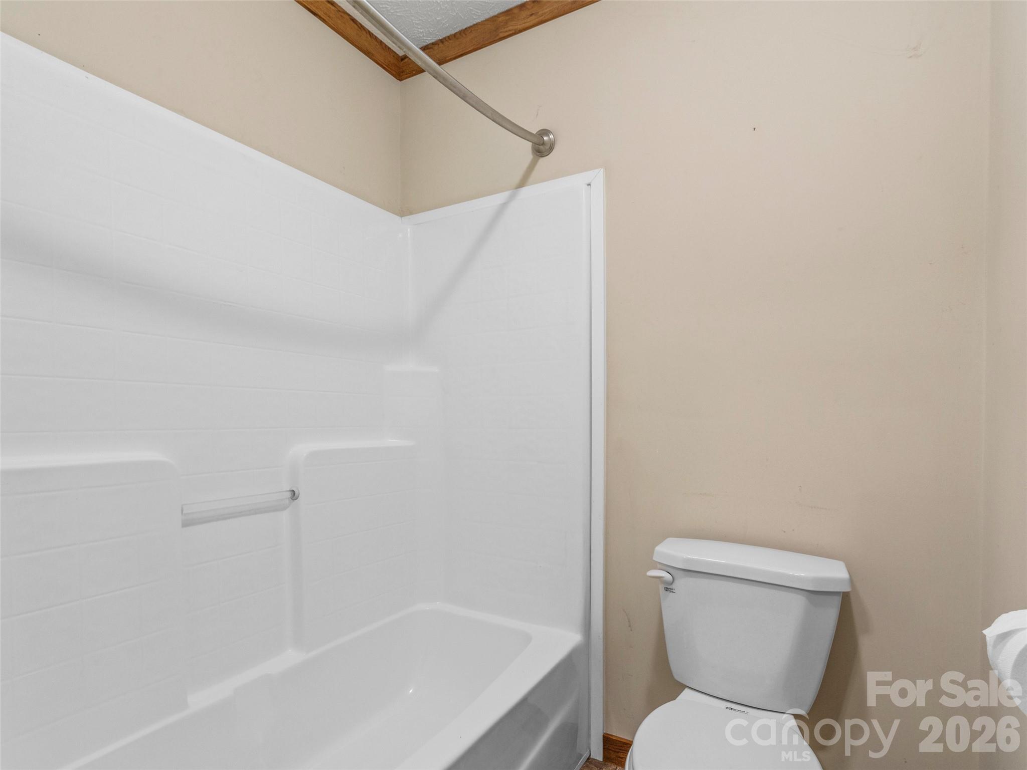 695 Johnson Farm Road Canton, NC 28716 - Photo 28 of 37 a bathroom with a toilet and tub