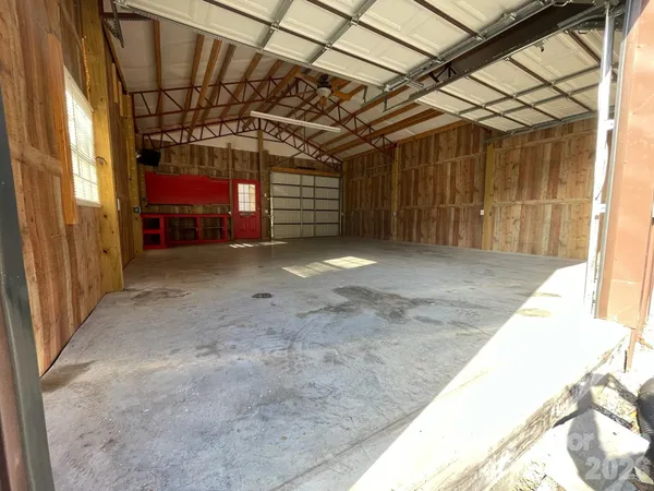 a view of empty room with wooden walls