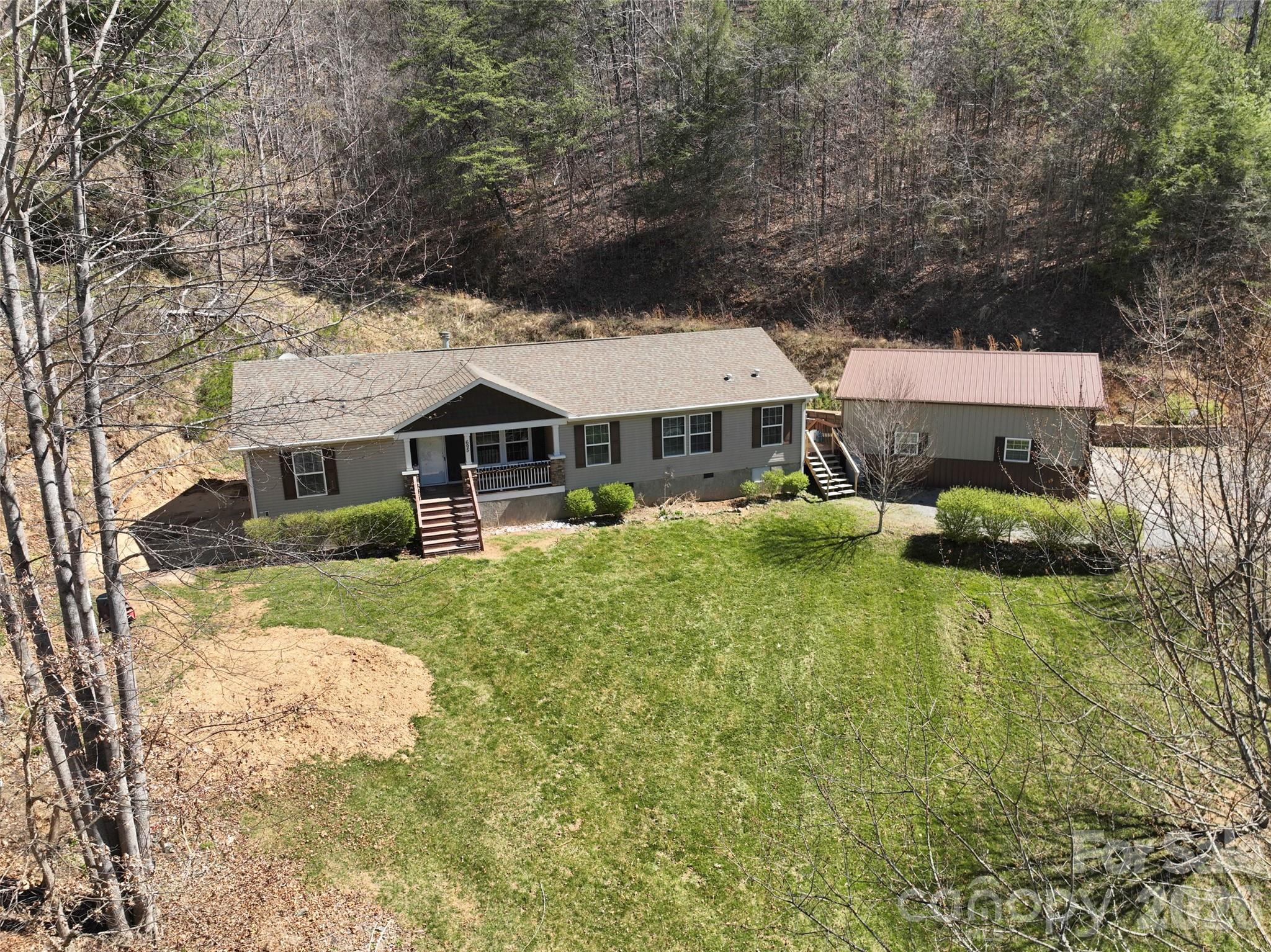 695 Johnson Farm Road Canton, NC 28716 - Photo 4 of 37 front view of a house with a yard