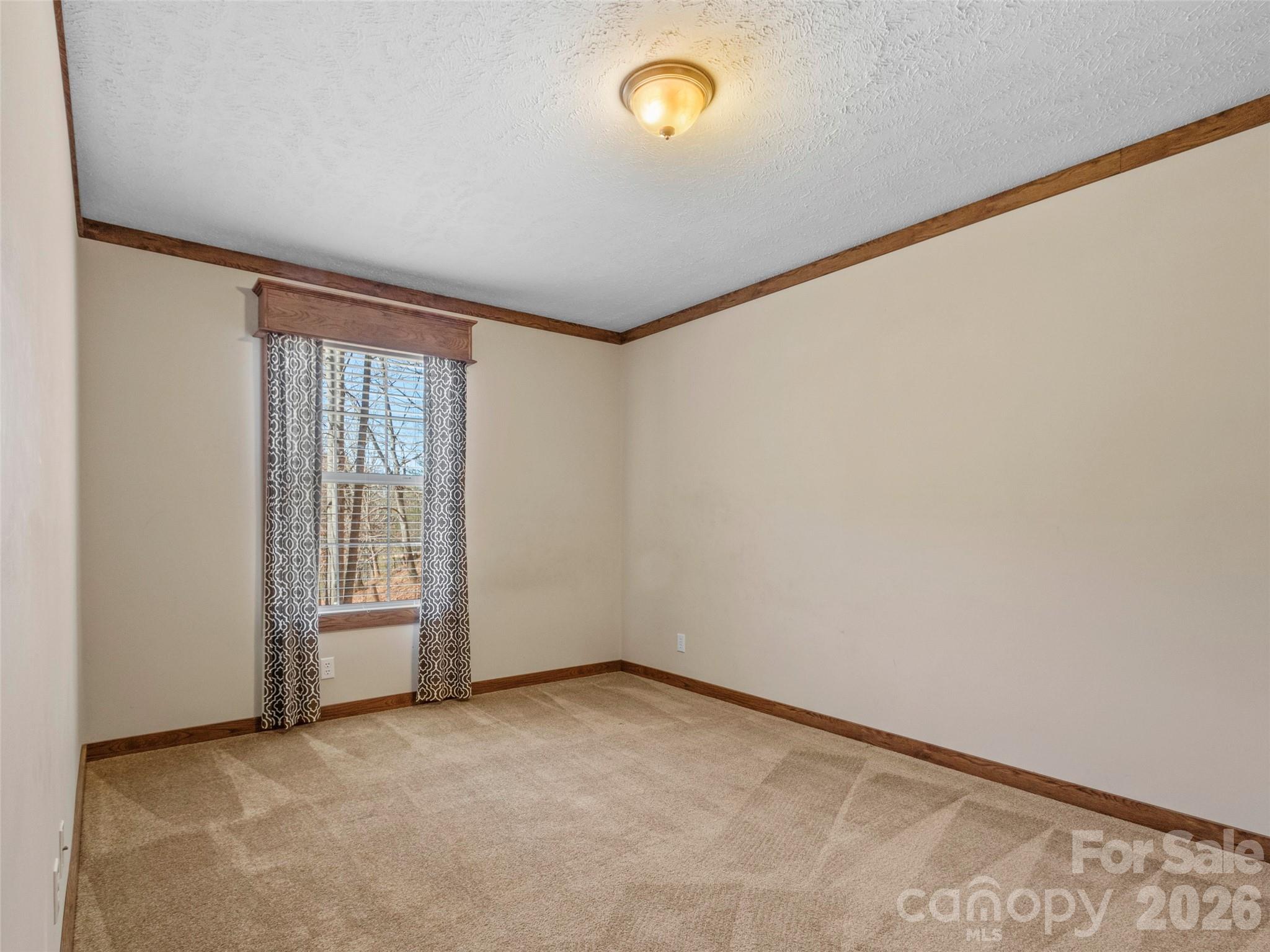 695 Johnson Farm Road Canton, NC 28716 - Photo 7 of 37 an empty room with wooden floor and windows