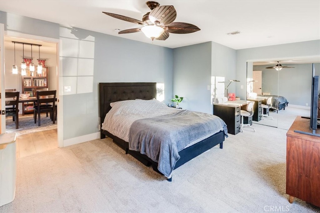 9541 Mandeville Road Santee, CA 92071 - Photo 25 of 46 a spacious bedroom with a bed and a chandelier