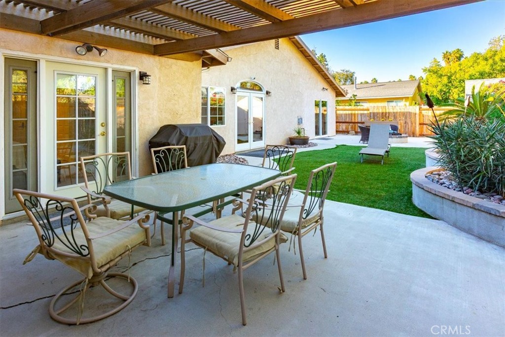 9541 Mandeville Road Santee, CA 92071 - Photo 35 of 46 a view of a patio with a table chairs and a backyard