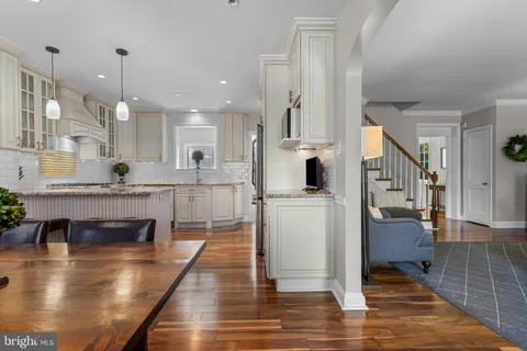 a kitchen with stainless steel appliances granite countertop a refrigerator a sink and a stove