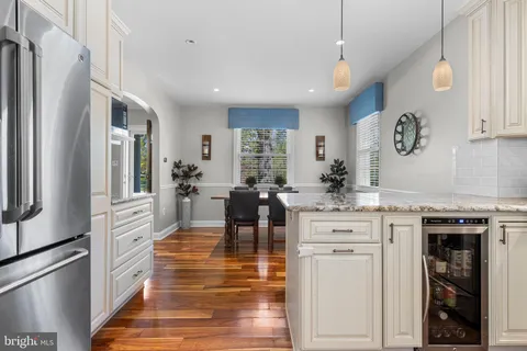 a view of a kitchen with wooden floor and electronic appliances