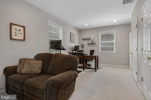 a work room with furniture and a window