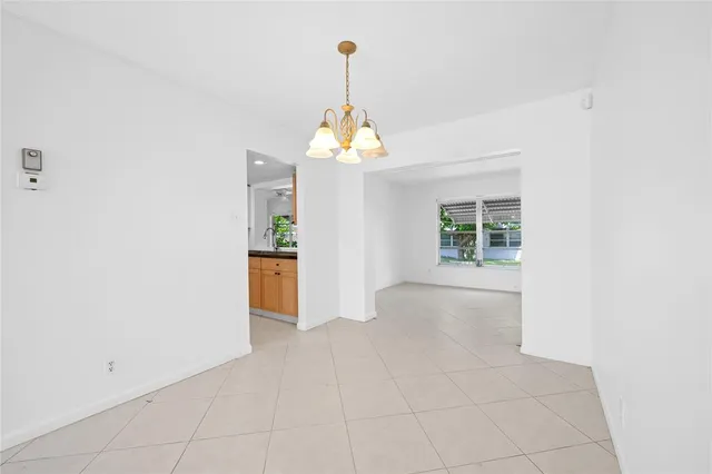 a view of an empty room with a kitchen