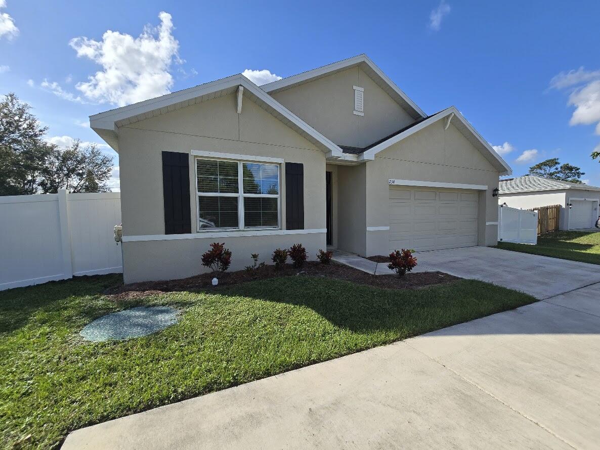 234 Southwest Becker Road Port St. Lucie, FL 34953 - Photo 1 of 44 a front view of a house with a yard and garage