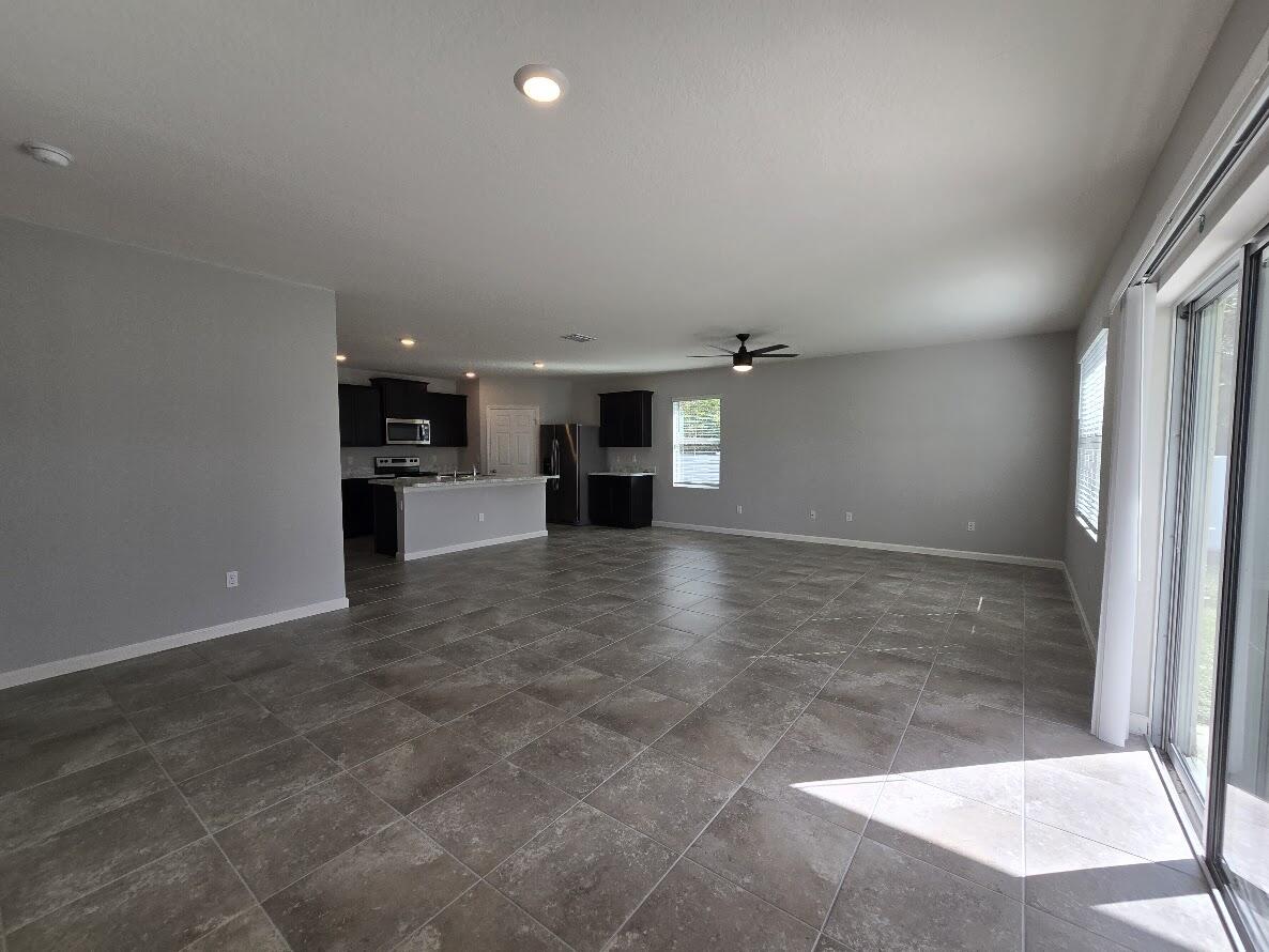 234 Southwest Becker Road Port St. Lucie, FL 34953 - Photo 17 of 44 an empty room with windows and cabinet