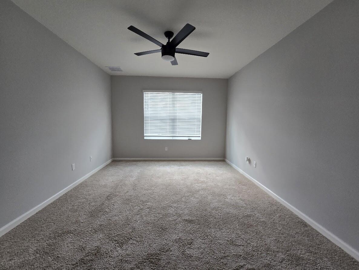 234 Southwest Becker Road Port St. Lucie, FL 34953 - Photo 22 of 44 an empty room with a ceiling fan and windows