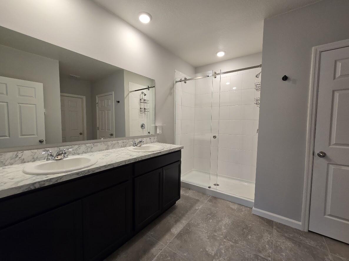 234 Southwest Becker Road Port St. Lucie, FL 34953 - Photo 23 of 44 a bathroom with double sink and a mirror