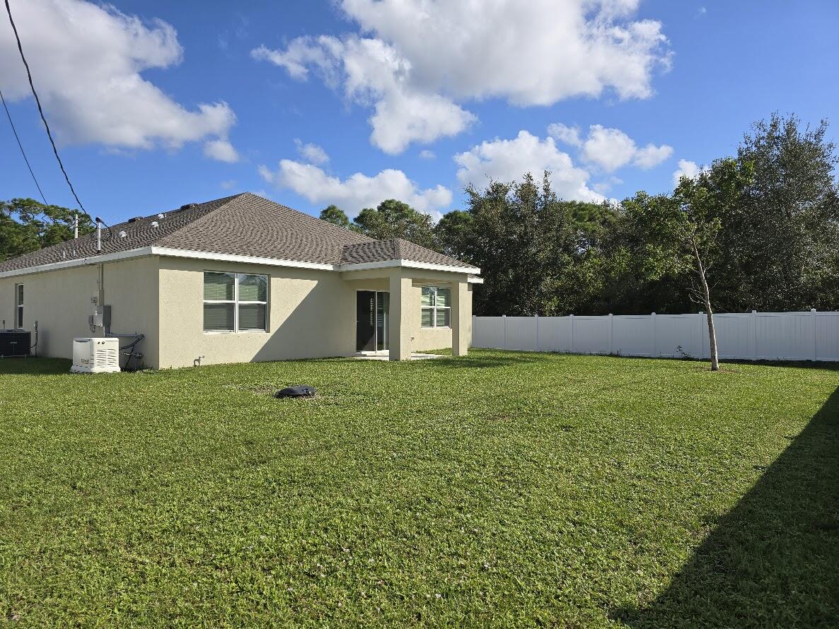 234 Southwest Becker Road Port St. Lucie, FL 34953 - Photo 4 of 44 a view of a house with a backyard