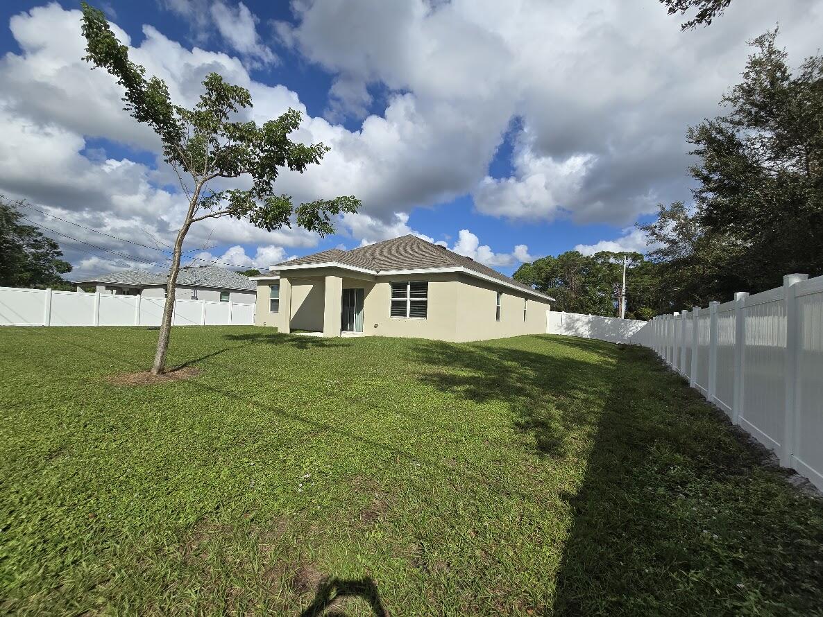 234 Southwest Becker Road Port St. Lucie, FL 34953 - Photo 5 of 44 a front view of a house with garden