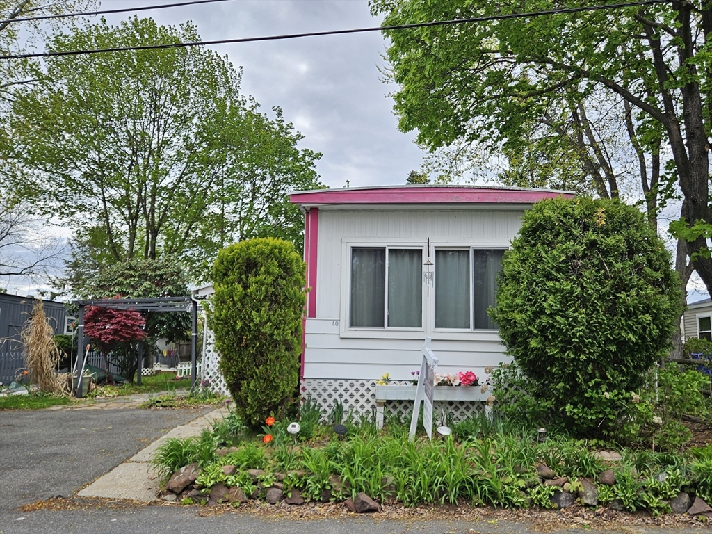40 Better Way Springfield, MA 01119 - Photo 2 of 24 a house with a flower garden in front of it