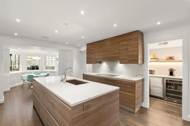 a front view of a house with a chairs and table in a patio
