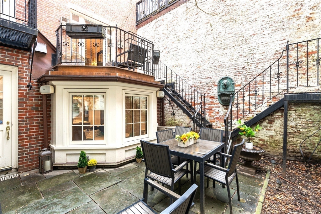 41 Chestnut Street Boston, MA 02108 - Photo 39 of 40 a front view of a house with a chairs and table in a patio