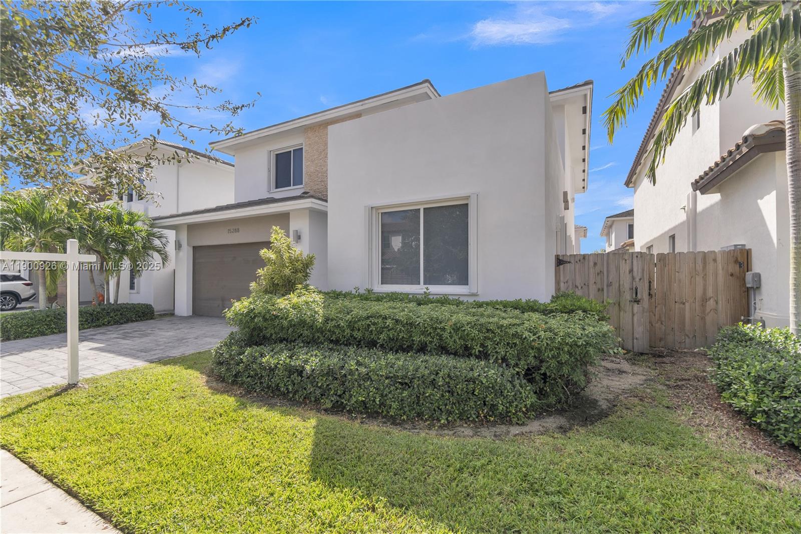 15288 Southwest 176th Terrace Miami, FL 33187 - Photo 14 of 68 a view of a white house next to a yard