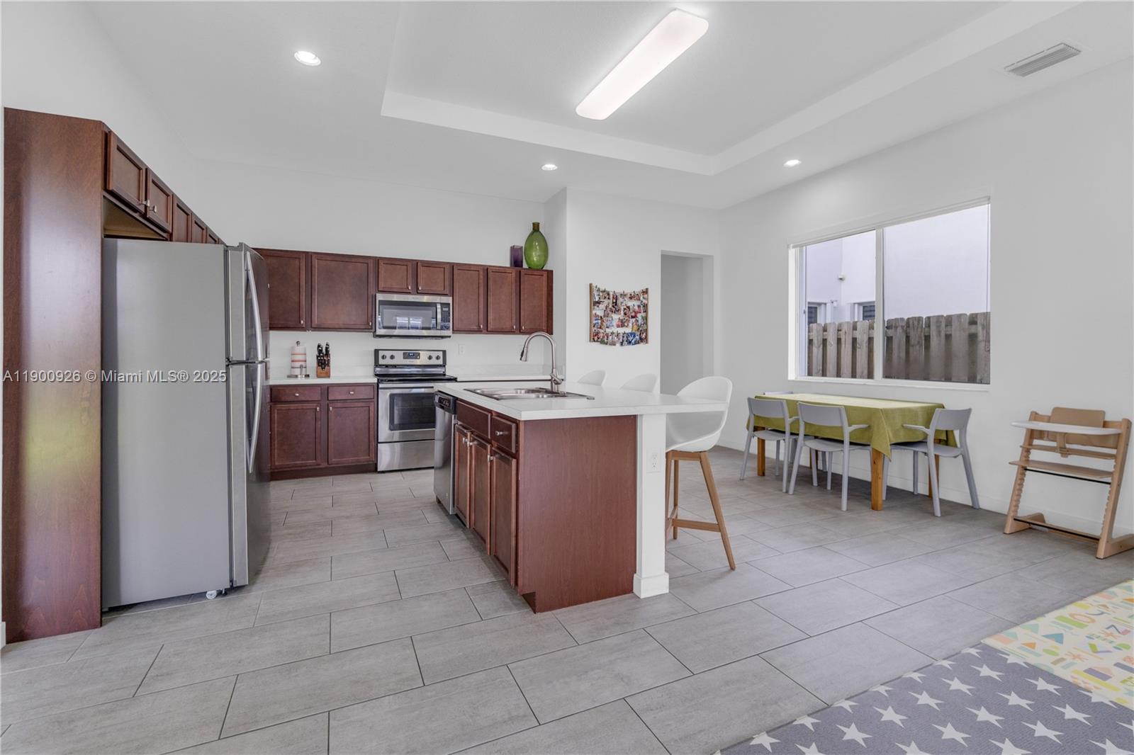 15288 Southwest 176th Terrace Miami, FL 33187 - Photo 15 of 68 a living room with stainless steel appliances furniture and a kitchen view