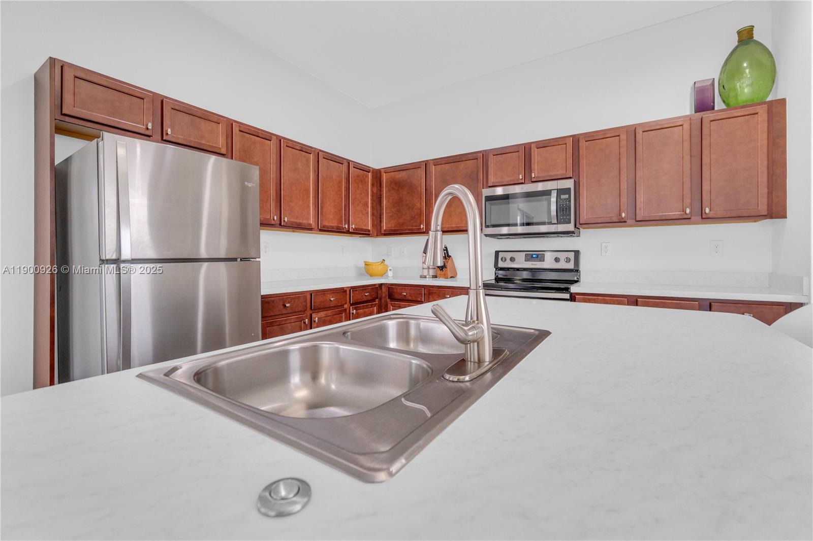 15288 Southwest 176th Terrace Miami, FL 33187 - Photo 18 of 68 a kitchen with a refrigerator a stove a sink and a cabinets