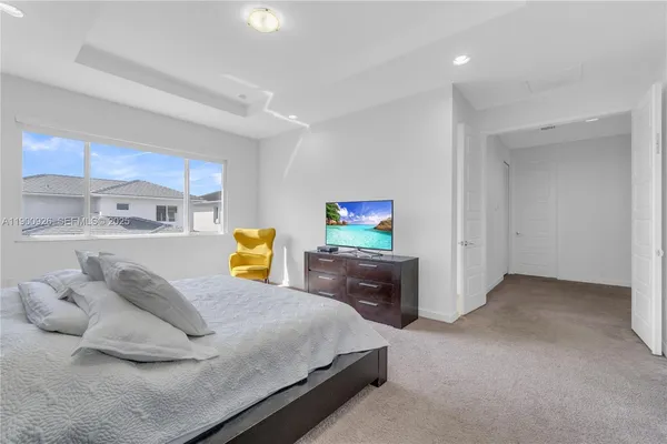 a bed room with a bed and a painting on the wall