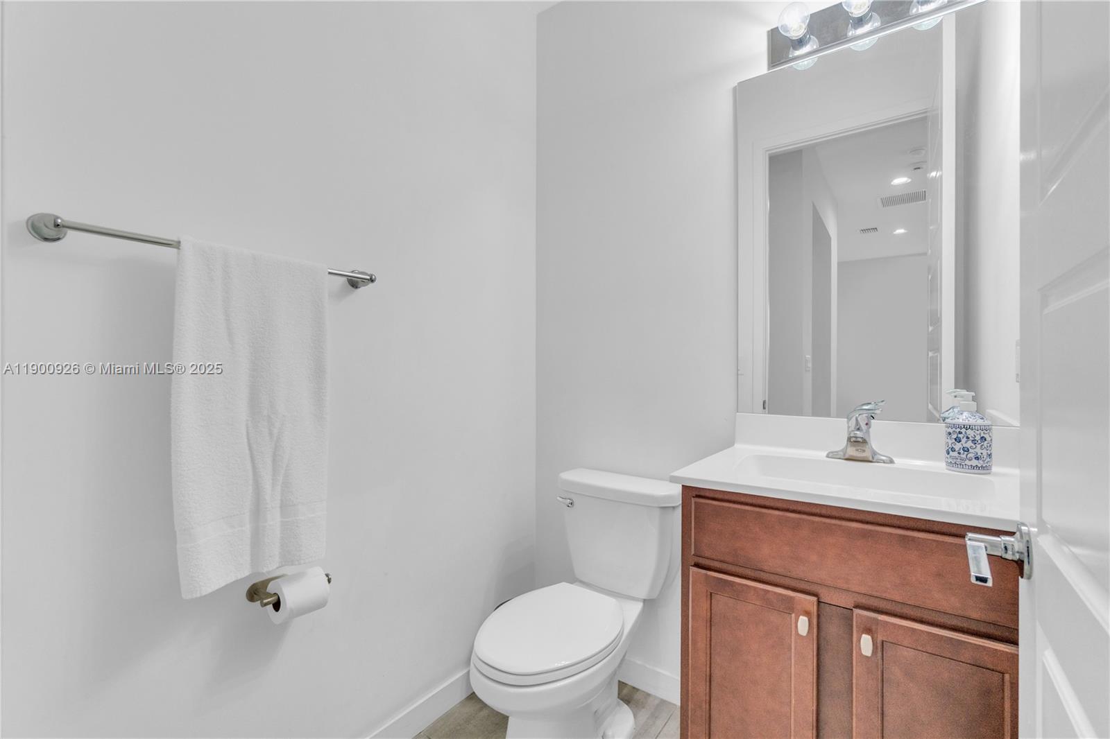 15288 Southwest 176th Terrace Miami, FL 33187 - Photo 47 of 68 a bathroom with a sink a toilet a mirror and shower