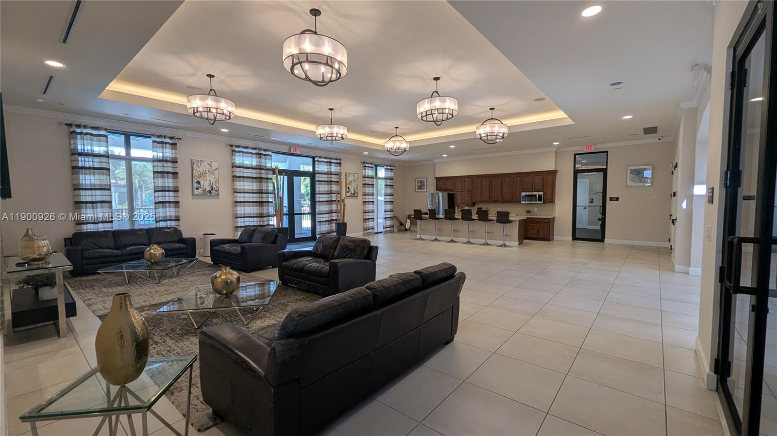 15288 Southwest 176th Terrace Miami, FL 33187 - Photo 62 of 68 a living room with furniture a chandelier and a large window