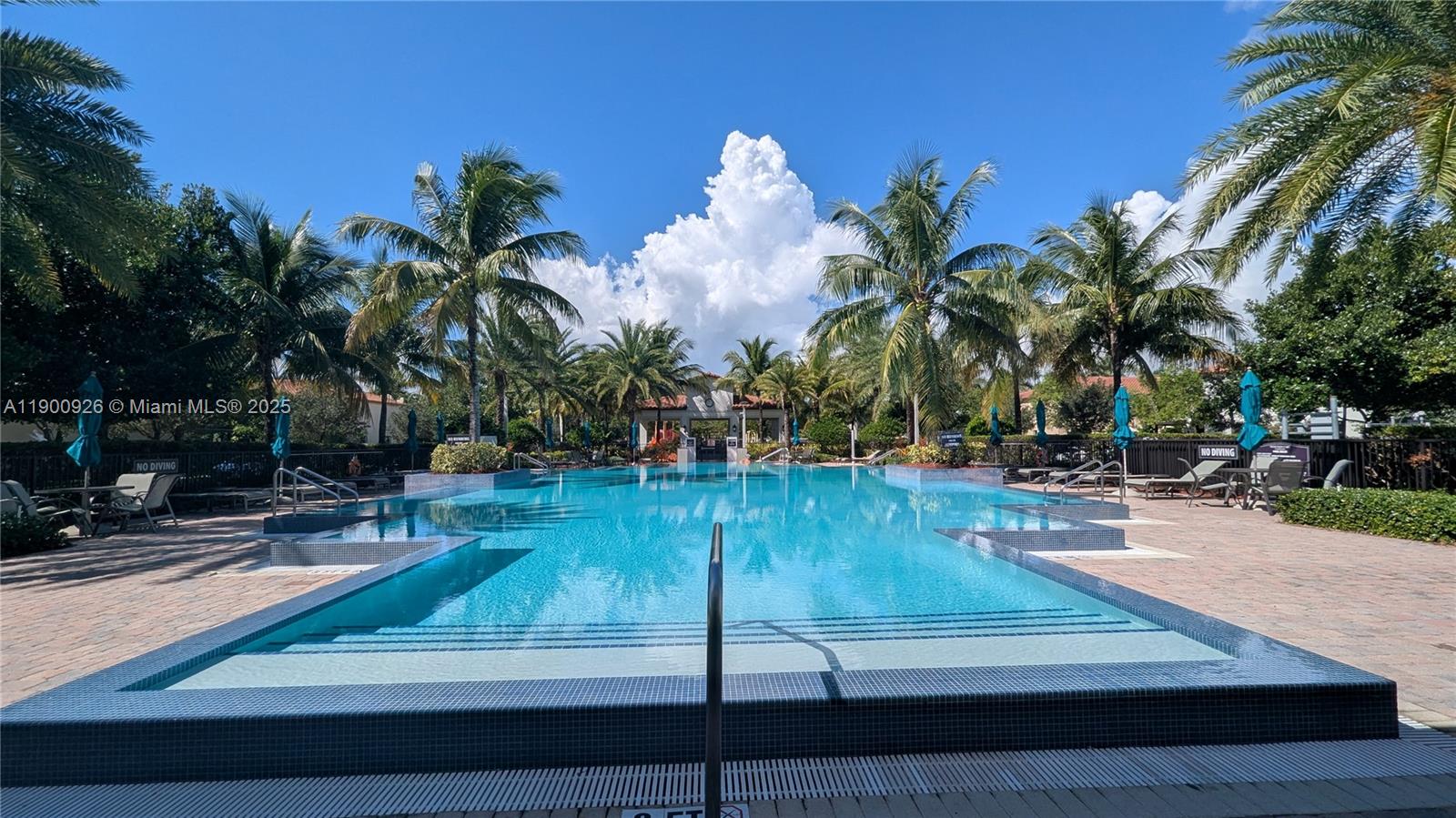 15288 Southwest 176th Terrace Miami, FL 33187 - Photo 63 of 68 a view of a swimming pool with a yard and palm trees