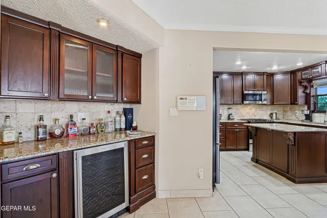 a bathroom with a granite countertop sink a toilet and a mirror