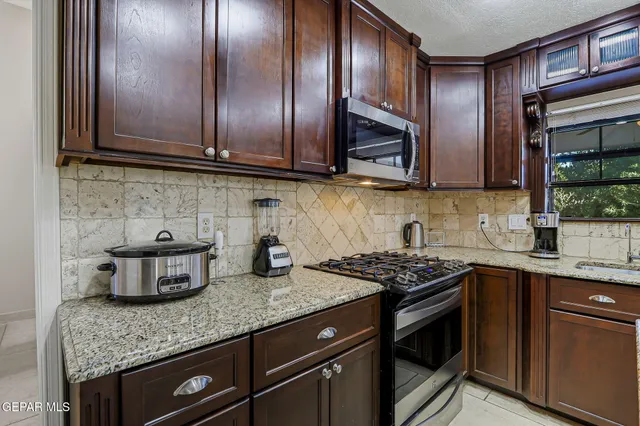 a bedroom with a bed and a flat tv screen on dresser