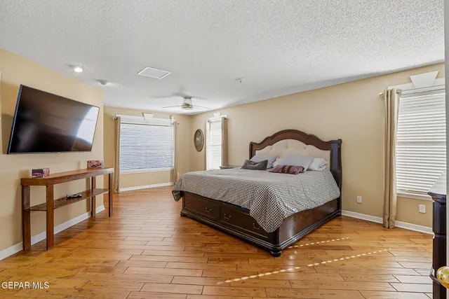 a view of a porch with a table and chairs under an umbrella