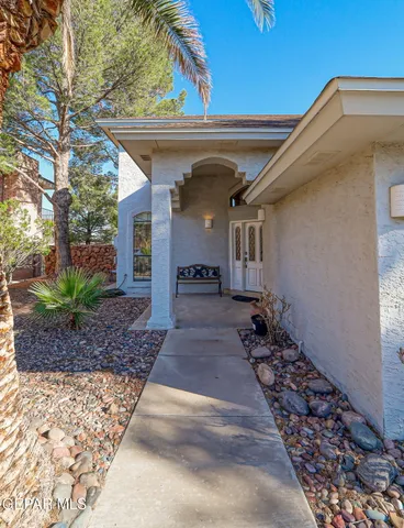 a living room with furniture paintings and a window