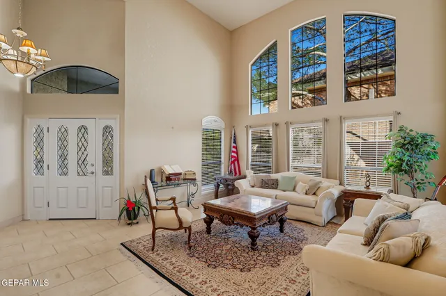 a view of a dining room with furniture and chandelier