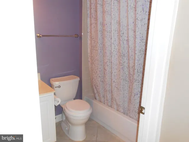 a white toilet sitting next to a shower