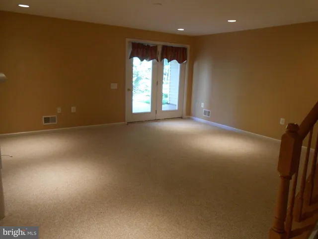 an empty room with windows and entrance
