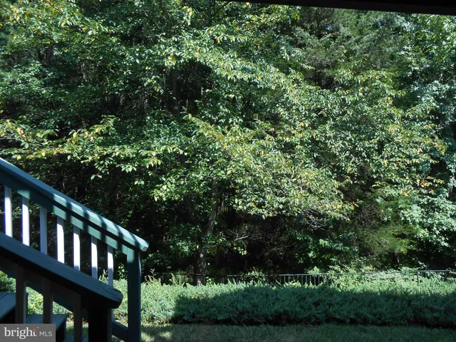 a view of wooden house and a yard