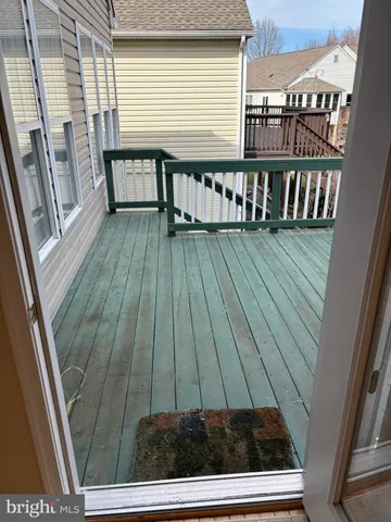 a view of a balcony with wooden floor