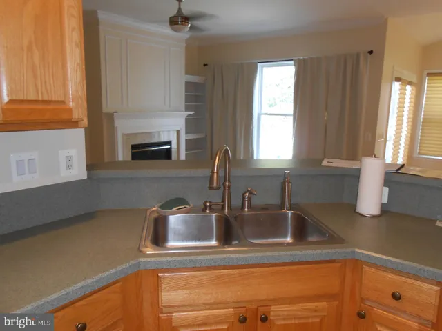a kitchen with a sink cabinets and a window