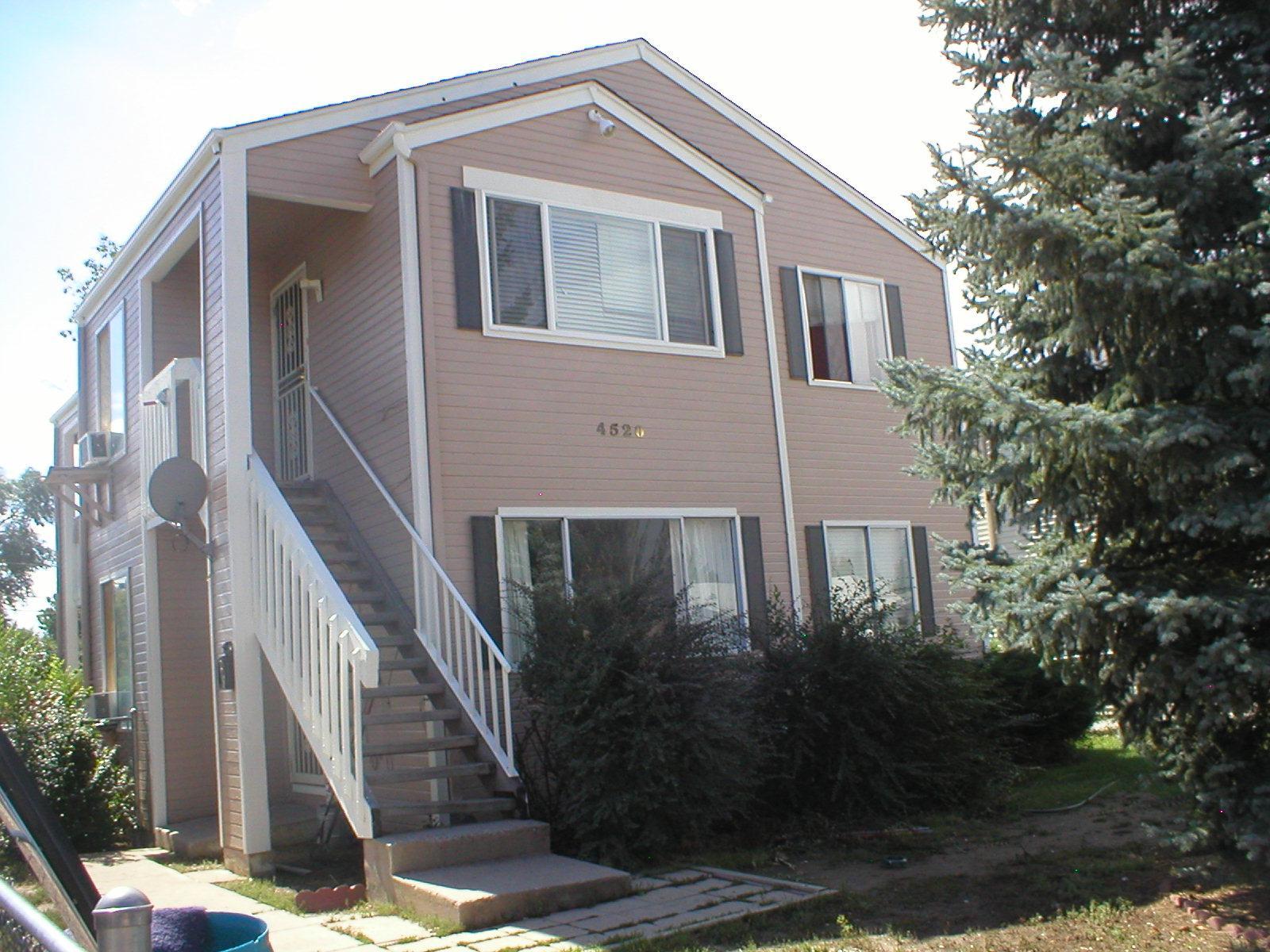 a front view of a house with plants