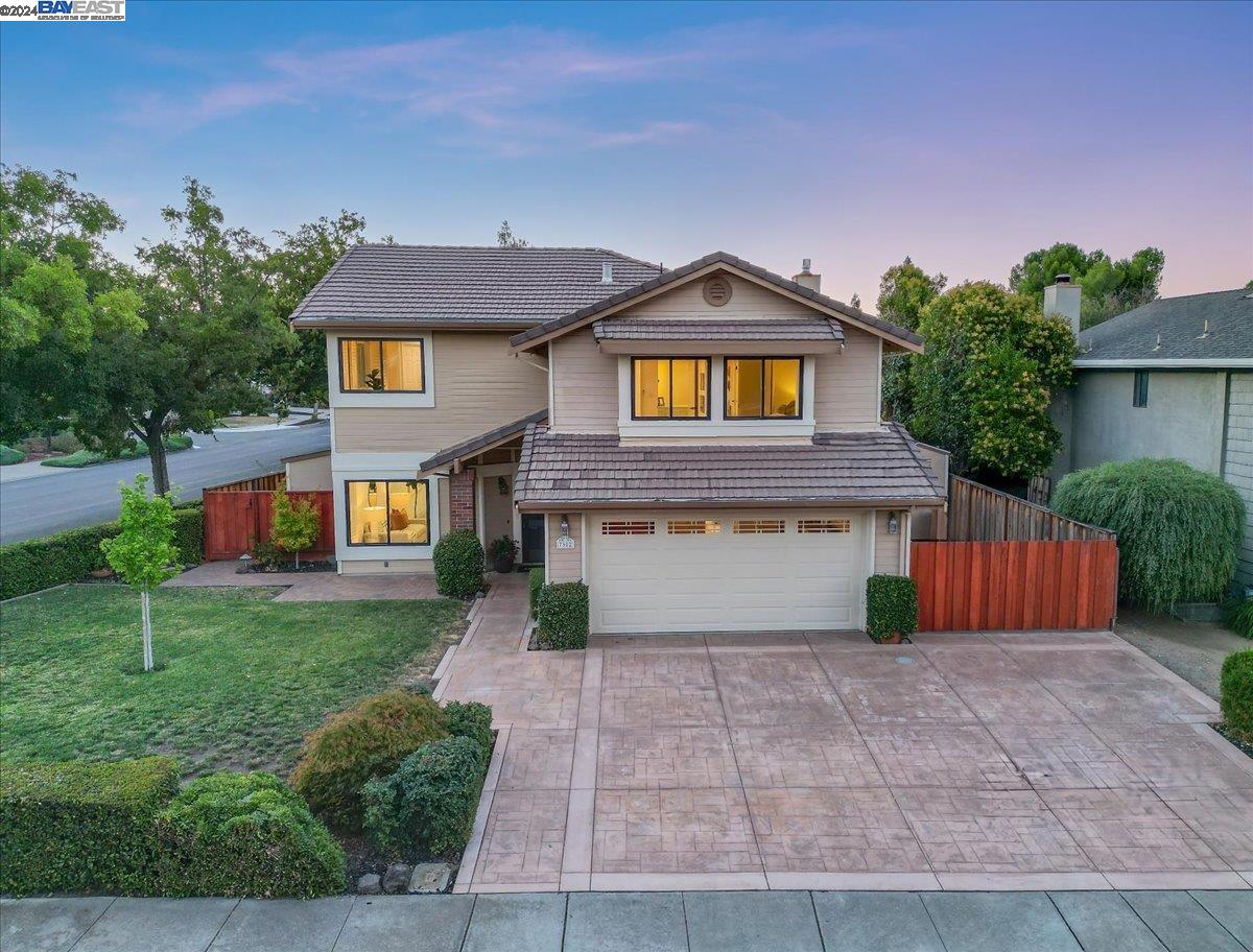 a front view of a house with a yard and a garage