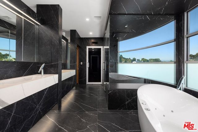 a bathroom with a bathtub and shower