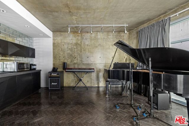 a bedroom with a bed and a flat tv screen on wall