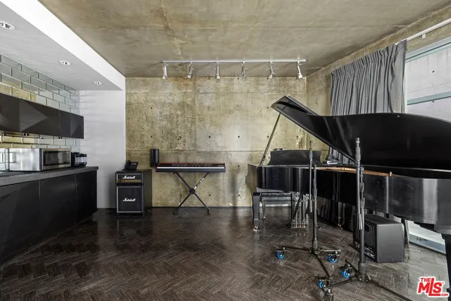 a bedroom with a bed and a flat tv screen on wall