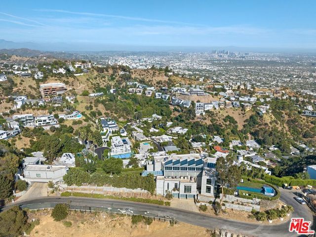 a view of a dining room with furniture and a chandelier