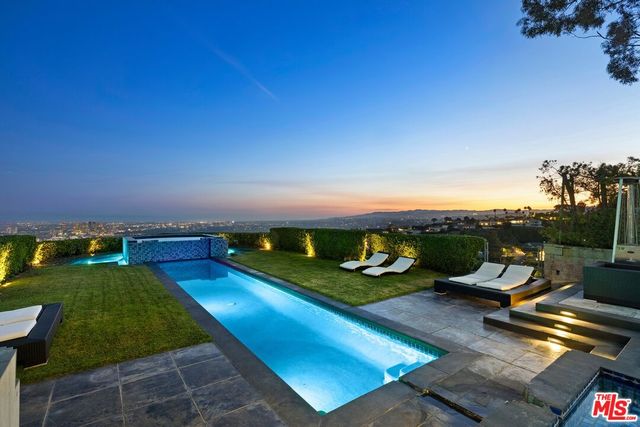 a view of a house with swimming pool yard and outdoor seating
