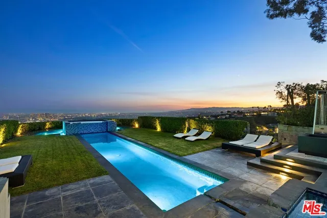 a view of a house with swimming pool yard and outdoor seating
