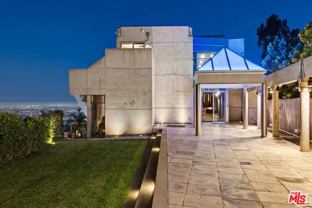 a view of a house with a backyard and a pond