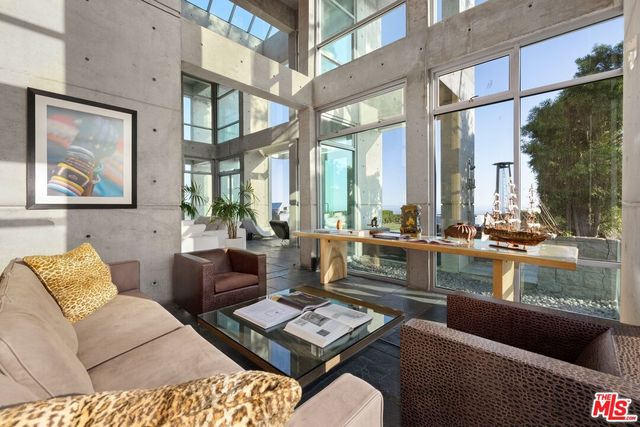 a living room with furniture and a floor to ceiling window