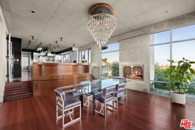 a dining room with furniture a chandelier and wooden floor