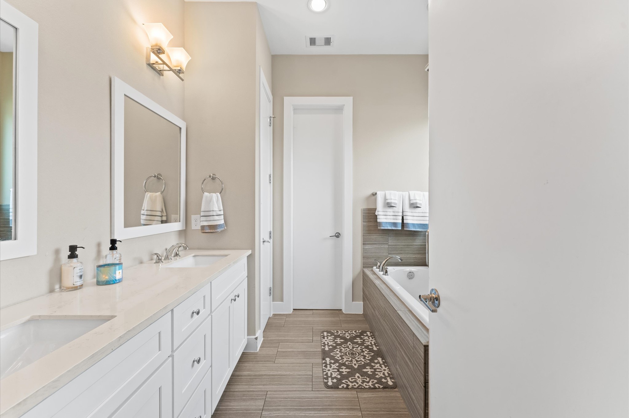 2422 Cochran Street Houston, TX 77009 - Photo 21 of 31 Step into the primary bath where a dual sink vanity rests across from the soaking tub and shower.